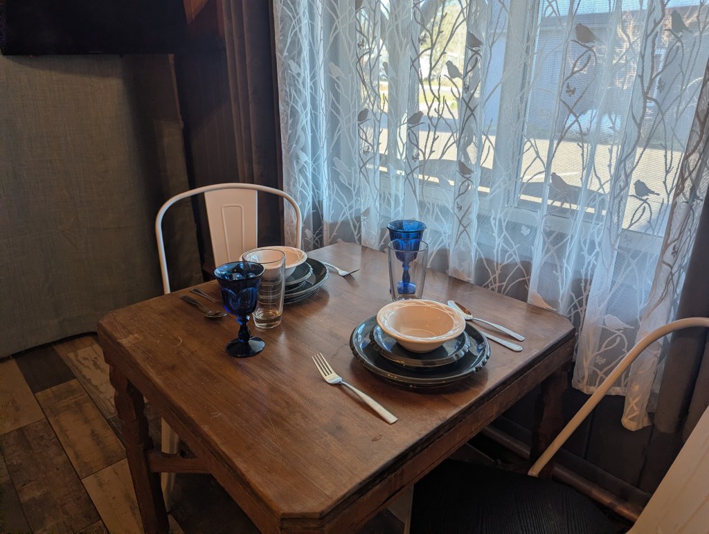 dining table set for two next to window