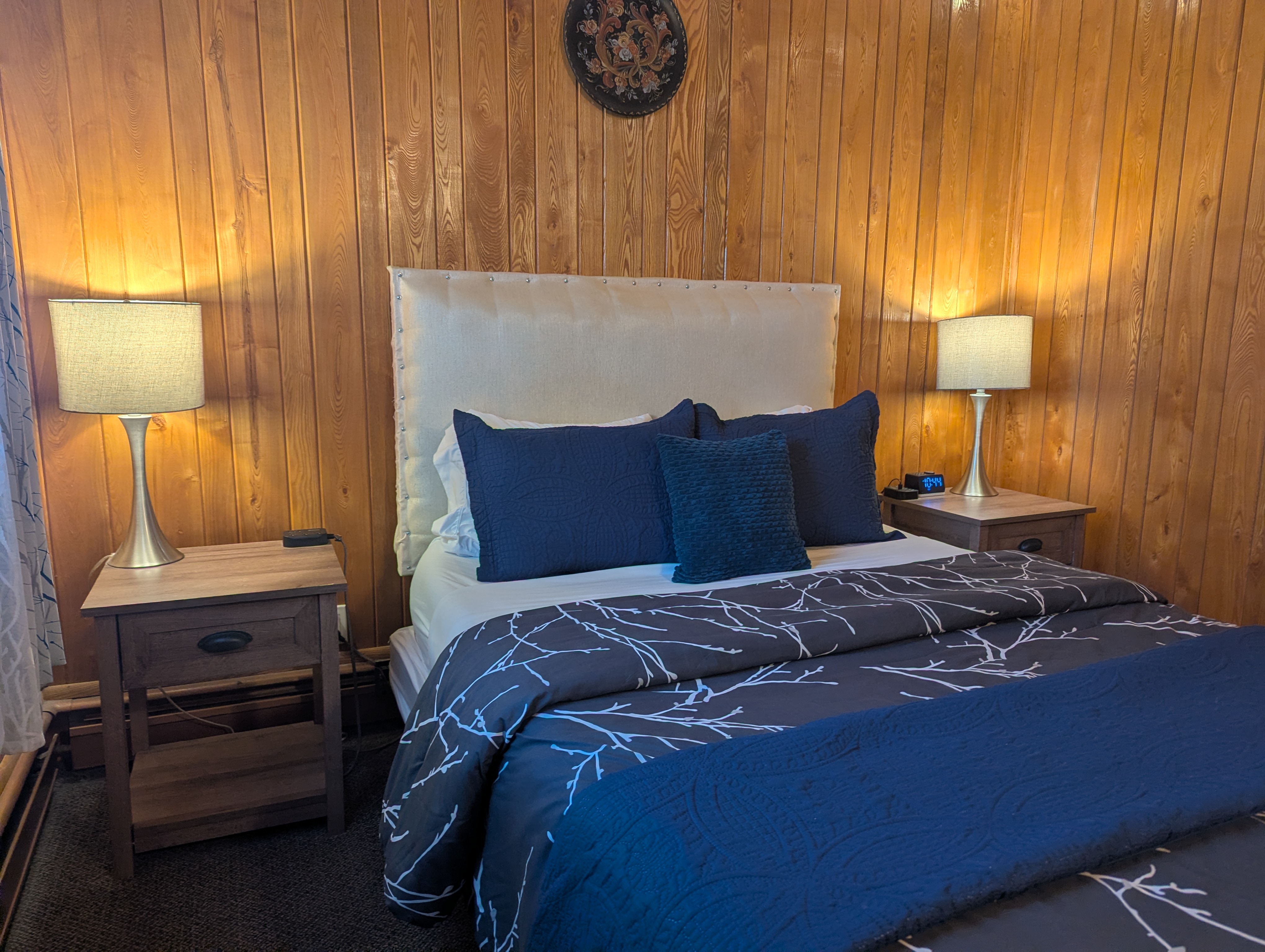 queen bed with white headboard and bedside tables