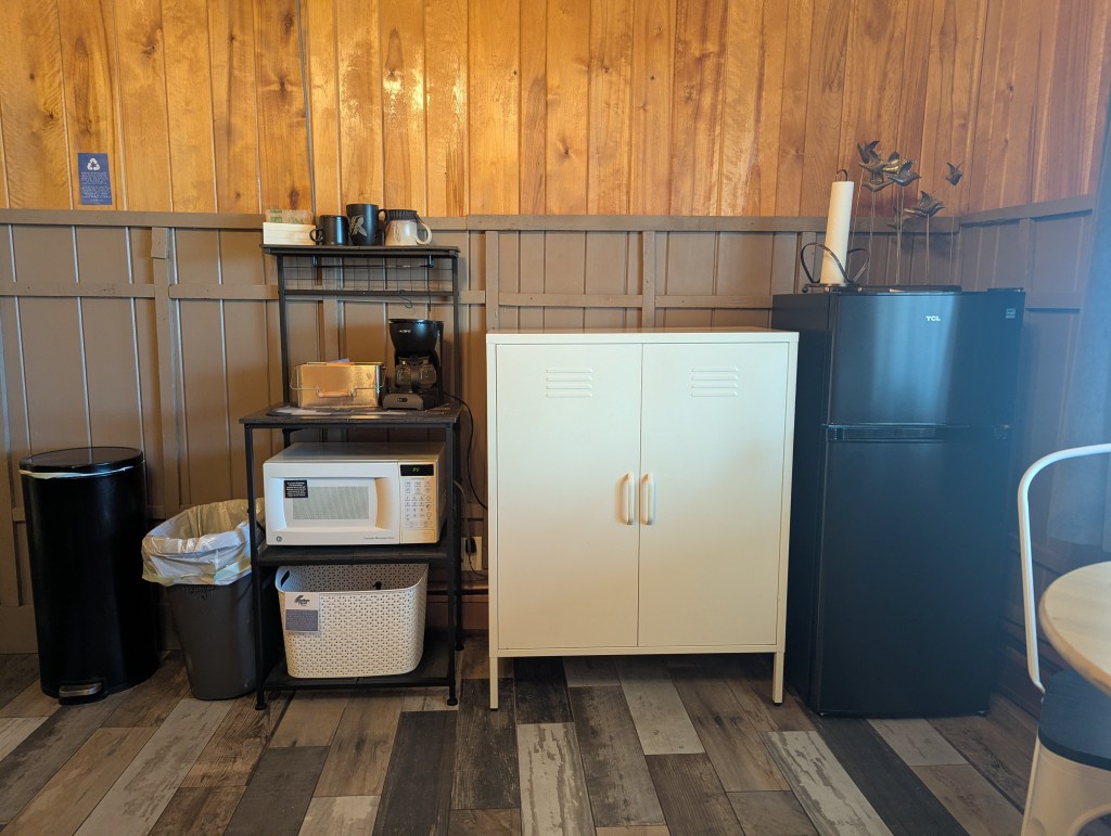 small kitchenette with microwave and fridge