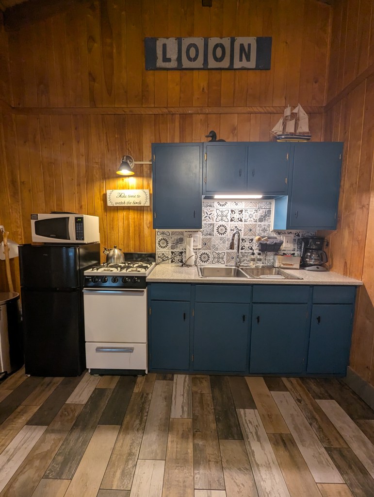 kitchen with sink, gas stove, and fridge
