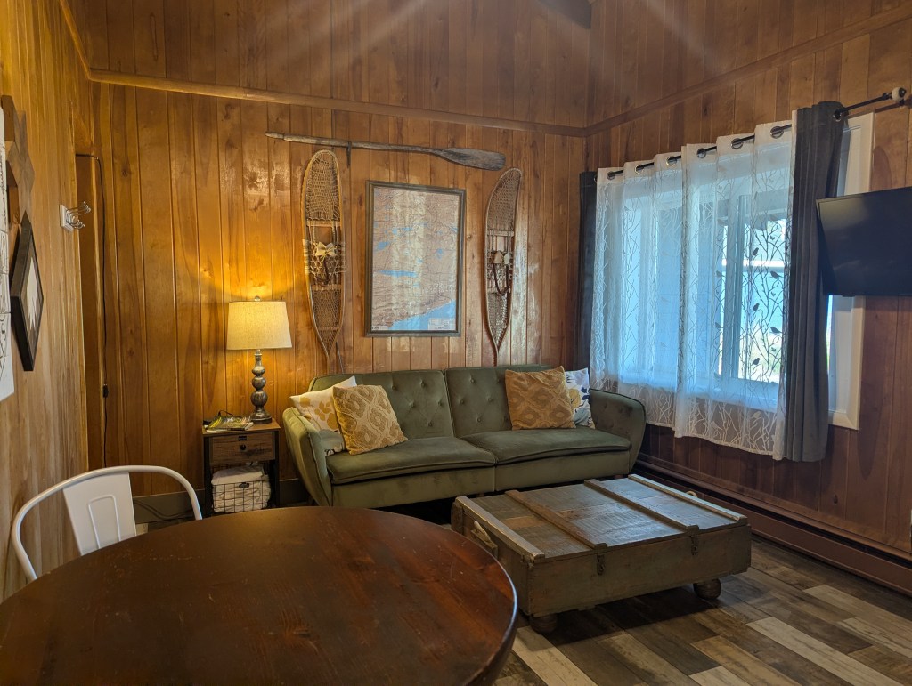 living room couch with window and mounted tv