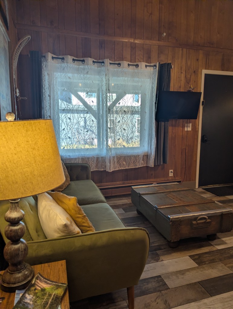 living room with TV mounted next to window