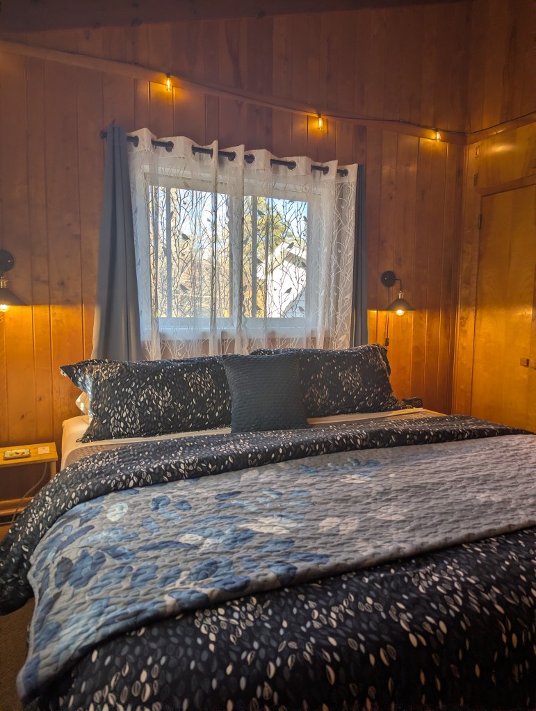 Large bed with window behind it