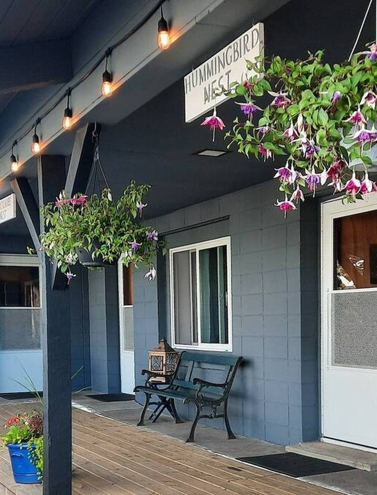 porch of guest rooms with hanging flowers